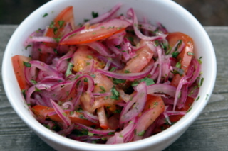 Onion and tomato curtido for salchipapas